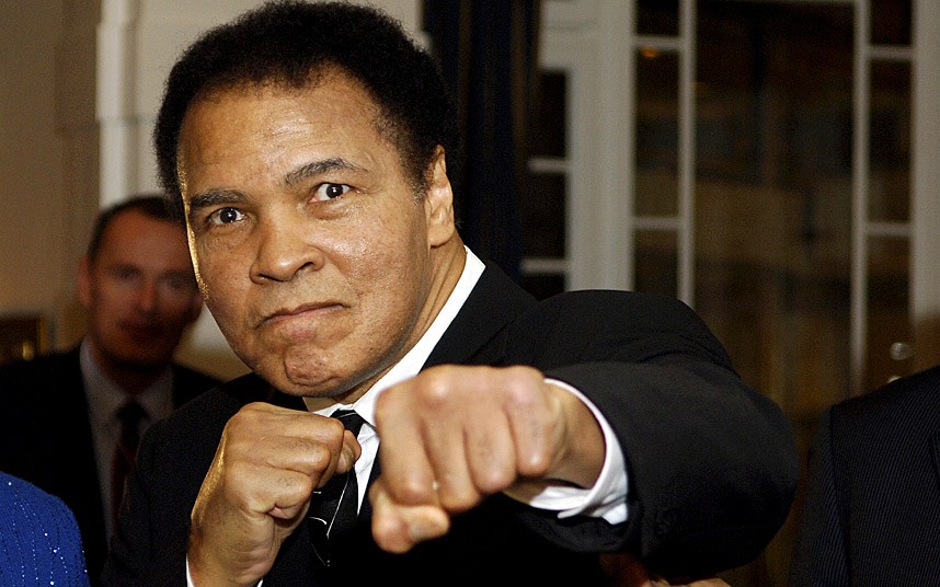 Muhammed Ali in his old age throwing a punch at the camera